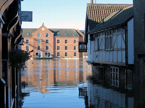 Town flooding, looking through old street building to new build
