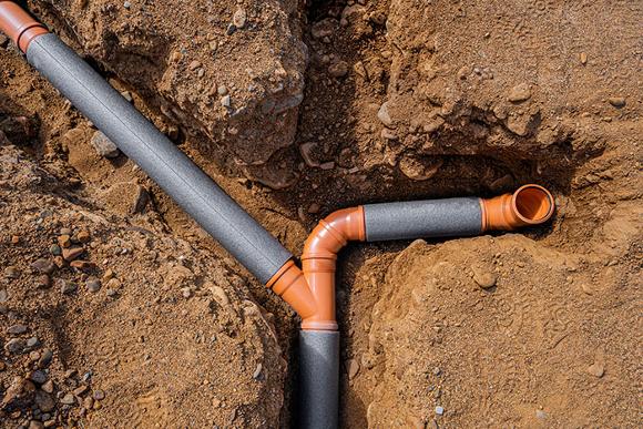 Drainage pipe installation in ground.